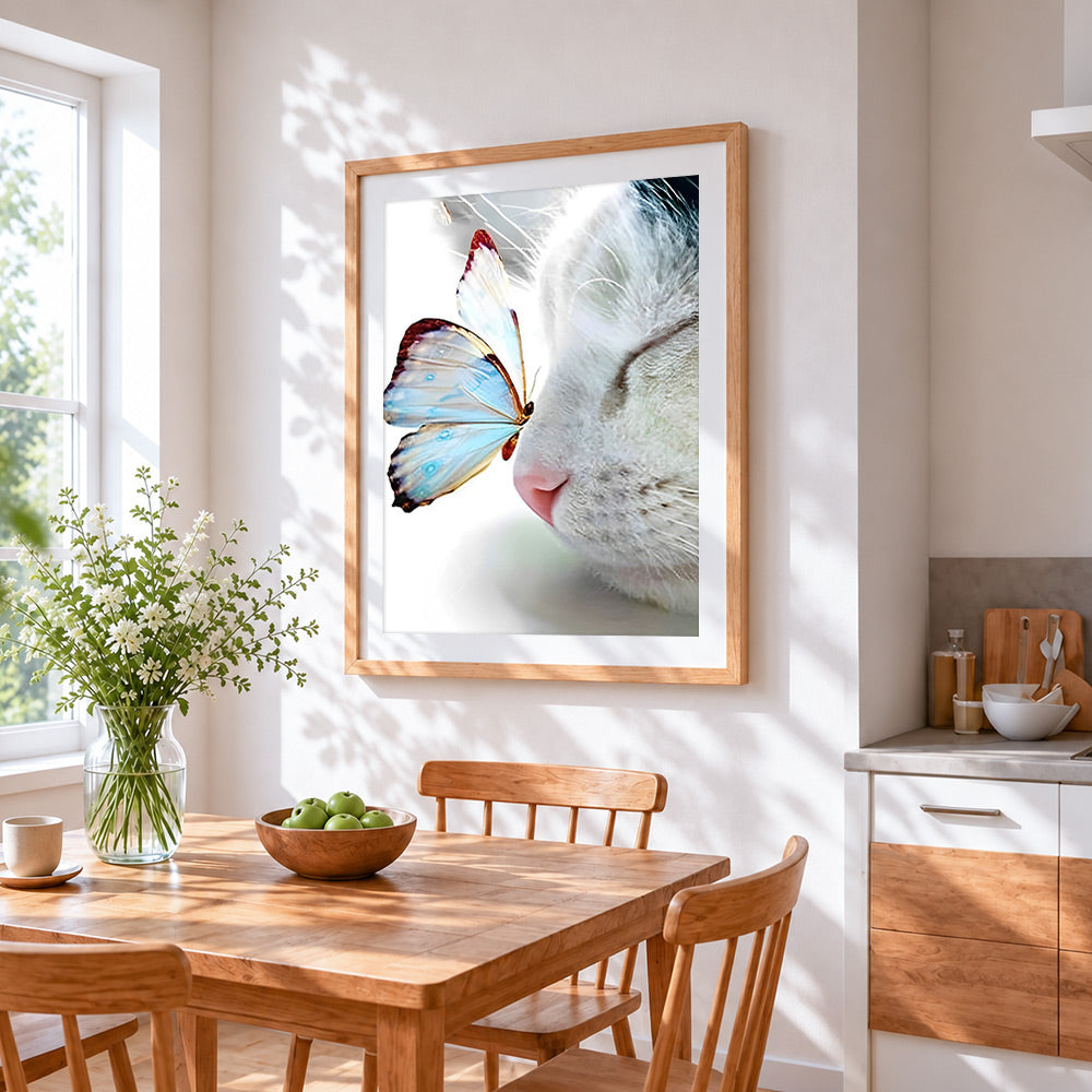 Butterfly on cat nose cross stitch artwork displayed on wall as home decor