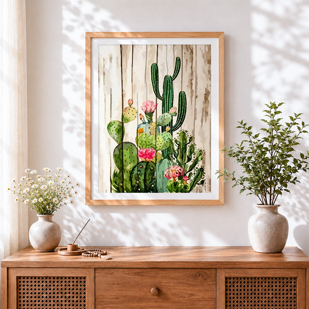 Finished cactus with pink flowers on wood cross stitch artwork displayed
