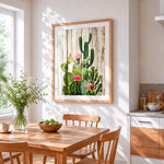 Cactus with pink flowers on wood cross stitch artwork displayed on wall as home decor
