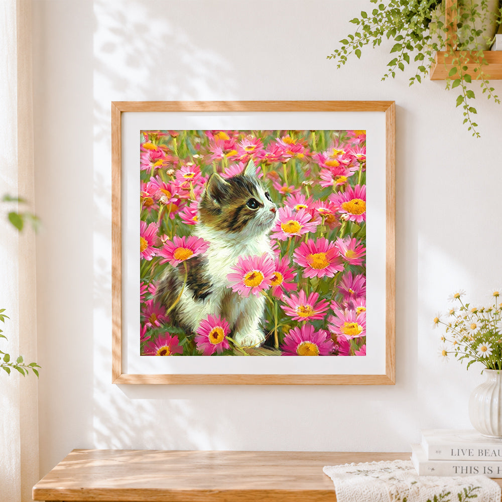 Finished calico kitten in pink daisies cross stitch artwork displayed
