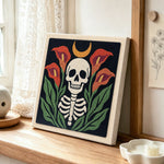 Calla lily skull punch needle artwork displayed on a table