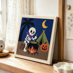 Camping skeleton punch needle artwork displayed on a table