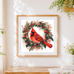 Finished cardinal bird in a holly wreath cross stitch artwork displayed