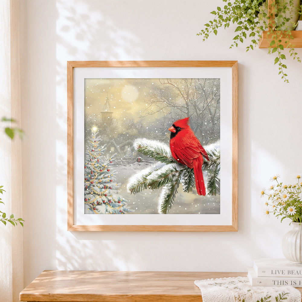 Finished cardinal bird in snow cross stitch artwork displayed