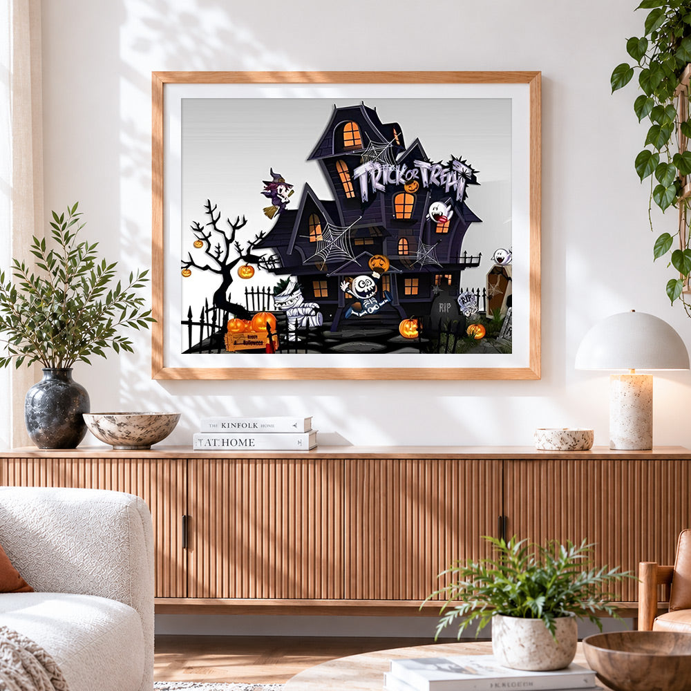 Finished cartoon haunted house trick or treat cross stitch artwork displayed