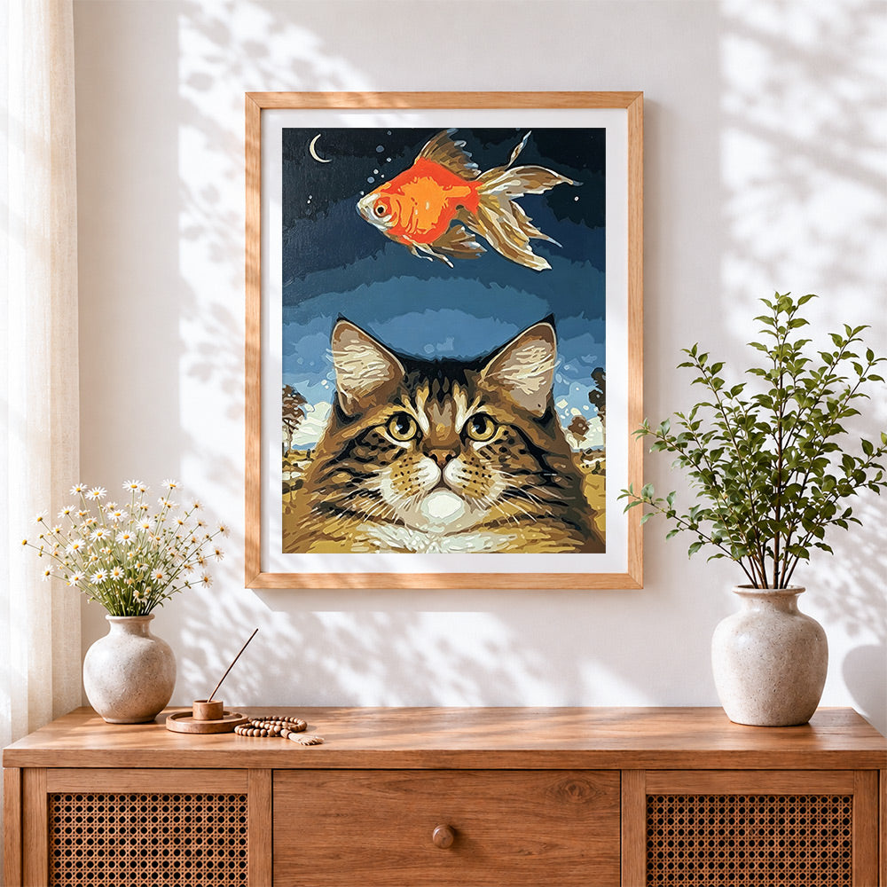 Finished cat and goldfish cross stitch artwork displayed