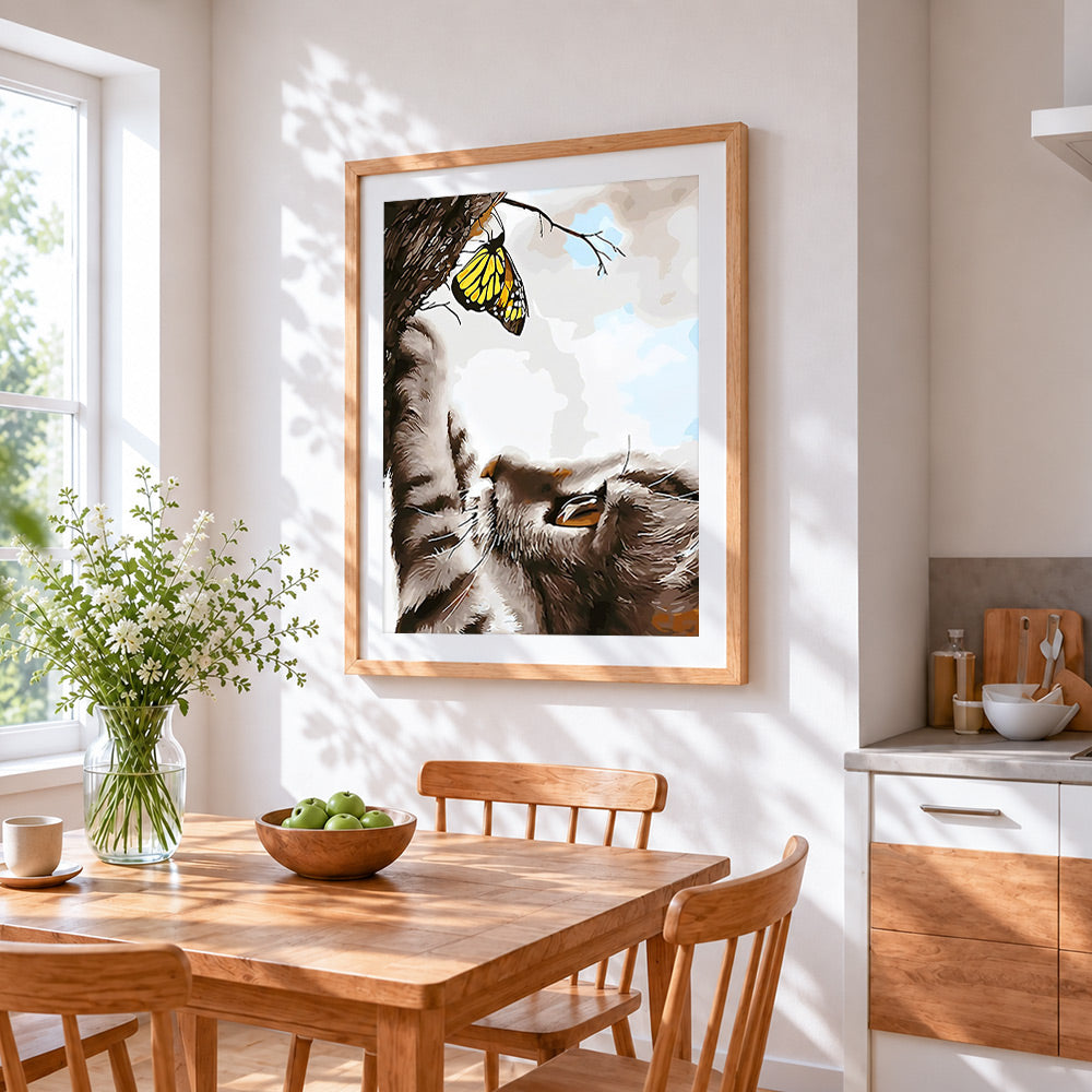 Cat and yellow butterfly cross stitch artwork displayed on wall as home decor