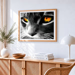 Cat eye close up cross stitch artwork displayed on wall as home decor