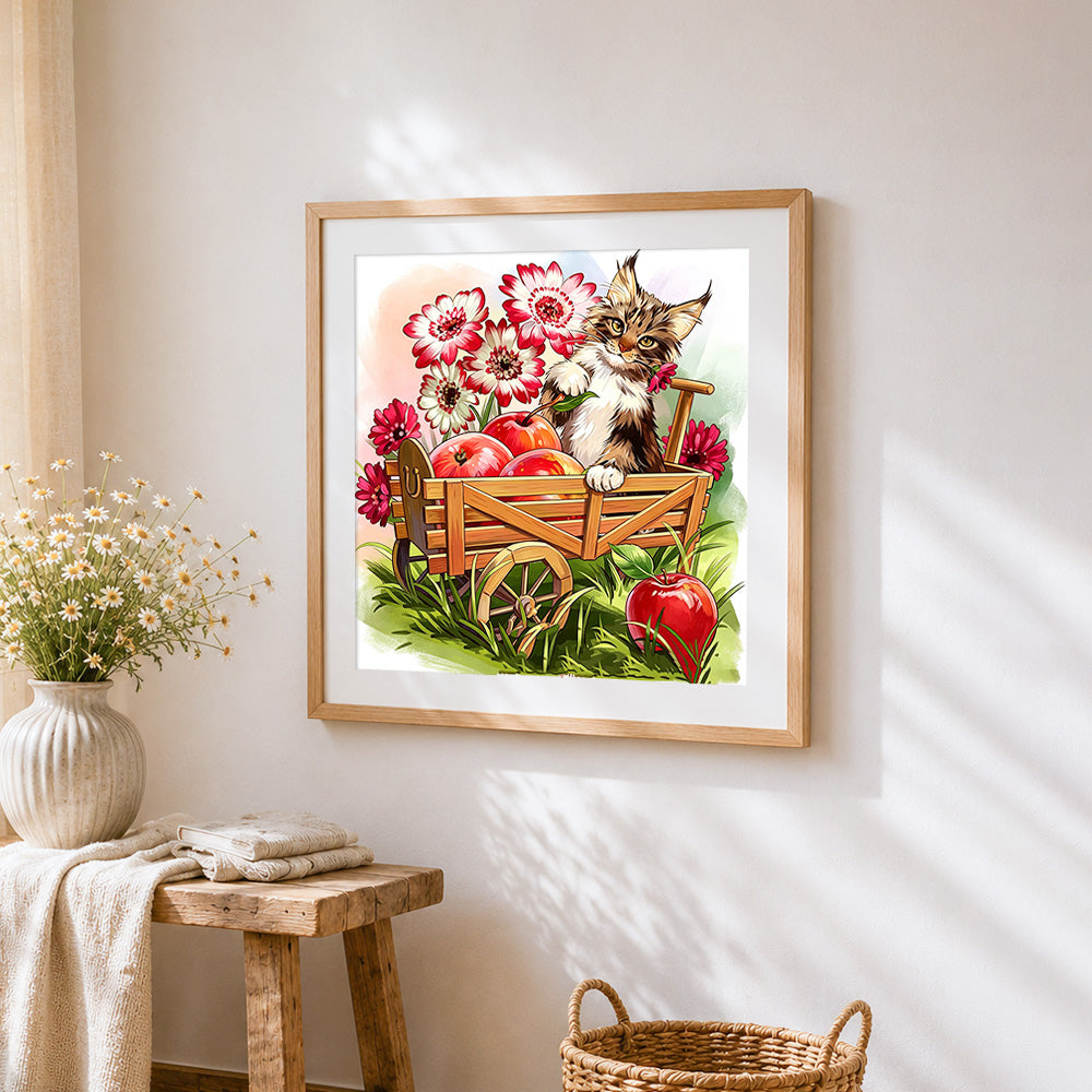 Cat in apple cart cross stitch artwork displayed on wall as home decor