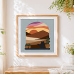 Finished cat in arch window sunset cross stitch artwork displayed