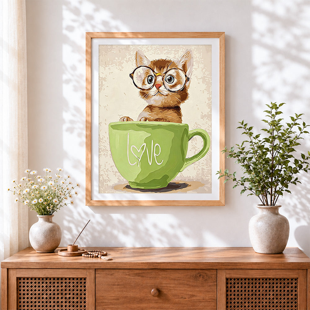Finished cat in green mug cross stitch artwork displayed