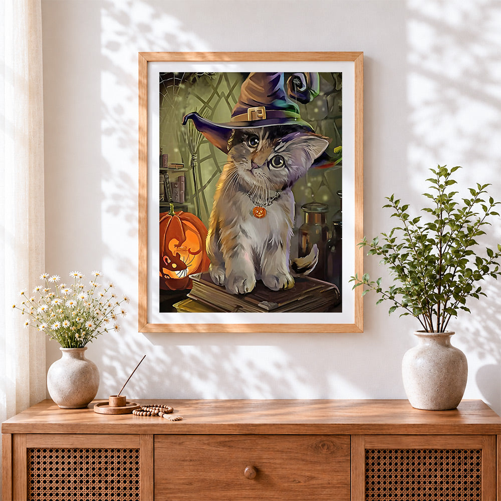 Finished cat in witch hat on spellbook cross stitch artwork displayed