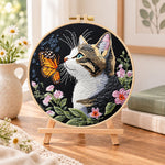 Cat meets monarch butterfly embroidery kit finished hoop displayed on a wooden stand as cosy tabletop decor