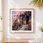 Finished cat on a porch with cherry blossoms cross stitch artwork displayed