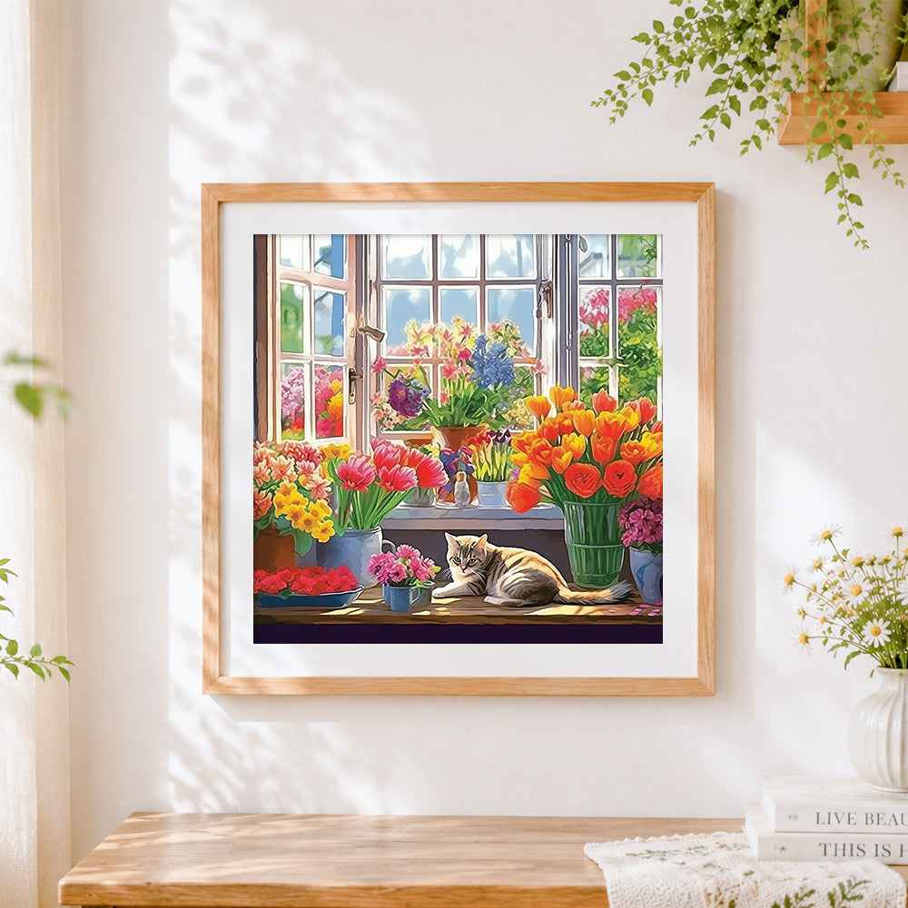Finished cat on a windowsill with vibrant flowers cross stitch artwork displayed