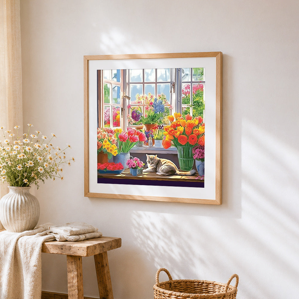 Cat on a windowsill with vibrant flowers cross stitch artwork displayed on wall as home decor