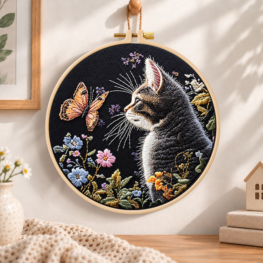 Cat watching butterfly embroidery hoop wall art displayed as warm and cosy handmade home decor