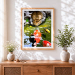 Finished cat watching koi fish cross stitch artwork displayed