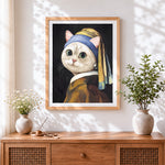 Finished cat with a pearl earring cross stitch artwork displayed