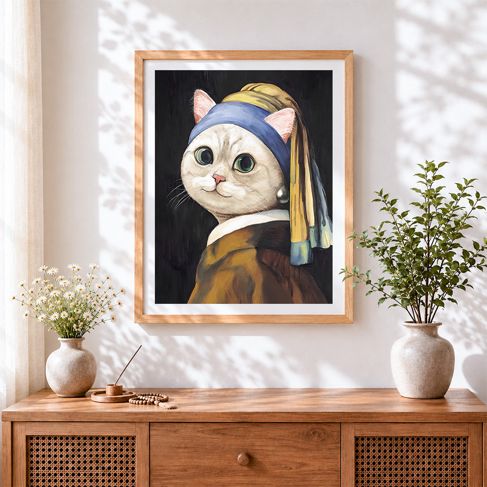 Finished cat with a pearl earring cross stitch artwork displayed
