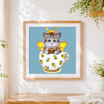 Finished cat with bee costume cross stitch artwork displayed