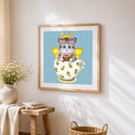Cat with bee costume cross stitch artwork displayed on wall as home decor