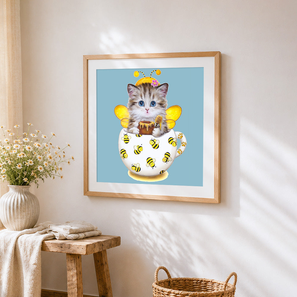 Cat with bee costume cross stitch artwork displayed on wall as home decor