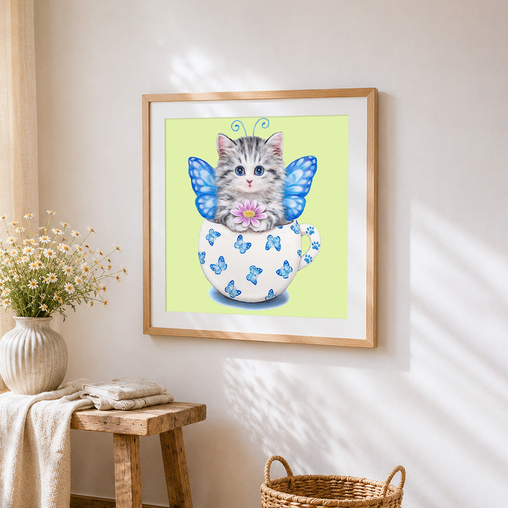 Cat with butterfly wings in teacup cross stitch artwork displayed on wall as home decor