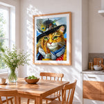 Cat with feather hat cross stitch artwork displayed on wall as home decor