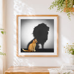 Finished cat with lion shadow cross stitch artwork displayed