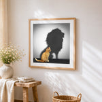 Cat with lion shadow cross stitch artwork displayed on wall as home decor