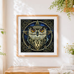 Finished celtic knot owl cross stitch artwork displayed
