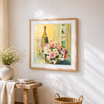 Champagne and roses basket still life cross stitch artwork displayed on wall as home decor