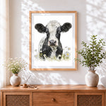 Finished charming cow with daisies cross stitch artwork displayed