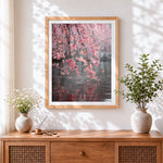 Finished cherry blossom branches over water cross stitch artwork displayed