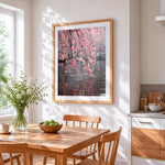Cherry blossom branches over water cross stitch artwork displayed on wall as home decor
