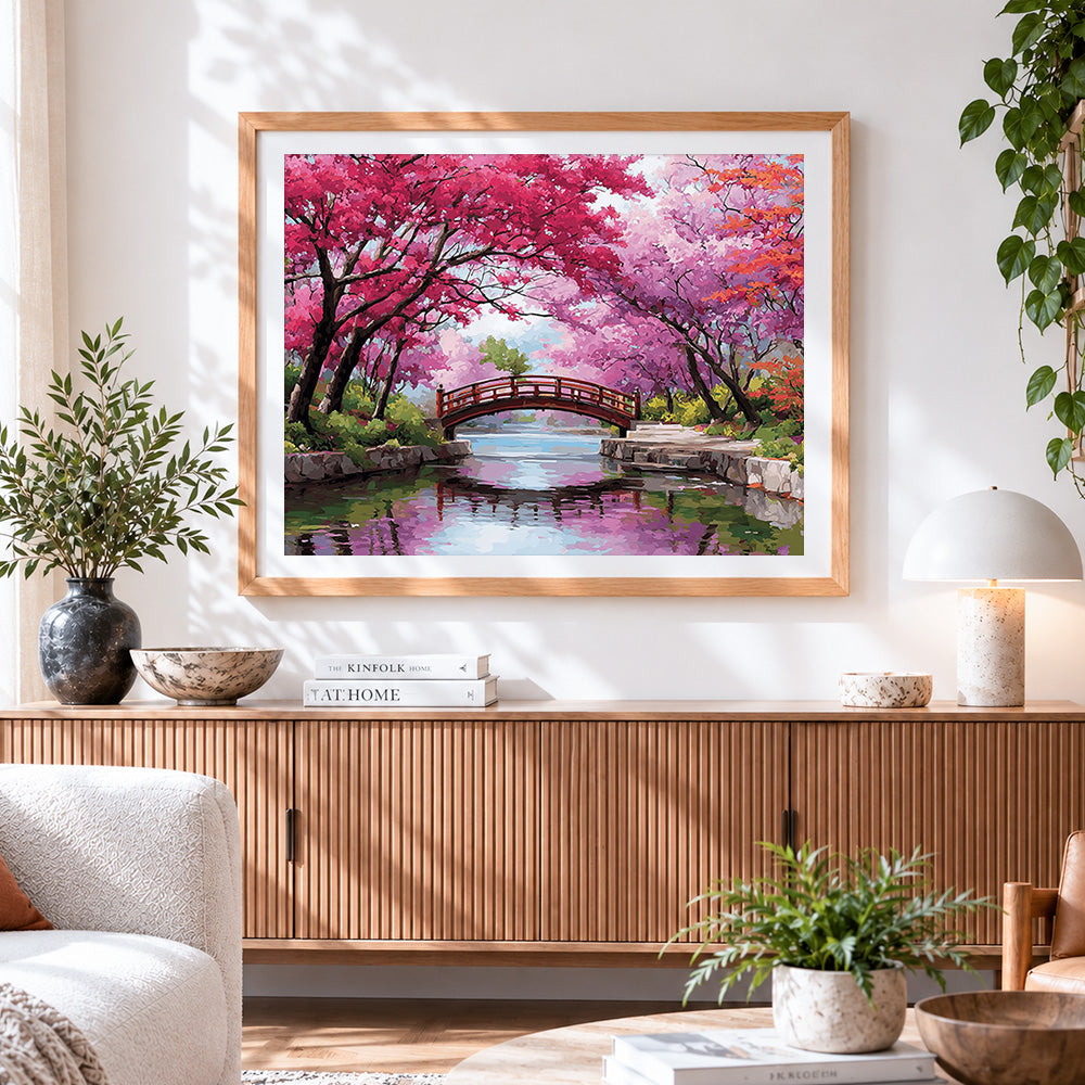 Finished cherry blossom bridge cross stitch artwork displayed