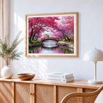Cherry blossom bridge cross stitch artwork displayed on wall as home decor