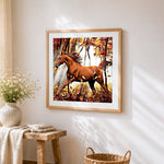 Chestnut horse running in autumn forest cross stitch artwork displayed on wall as home decor