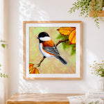 Finished chickadee on autumn branch cross stitch artwork displayed