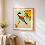 Chickadee on autumn branch cross stitch artwork displayed on wall as home decor