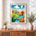 Finished childlike red car and colourful cottages cross stitch artwork displayed