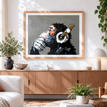 Finished chimpanzee with headphones cross stitch artwork displayed