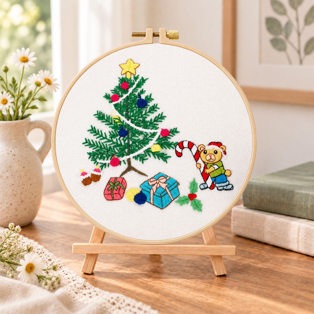 Christmas bear tree embroidery kit finished hoop displayed on a wooden stand as cosy tabletop decor