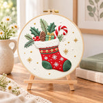 Christmas fireplace stocking embroidery kit finished hoop displayed on a wooden stand as cosy tabletop decor