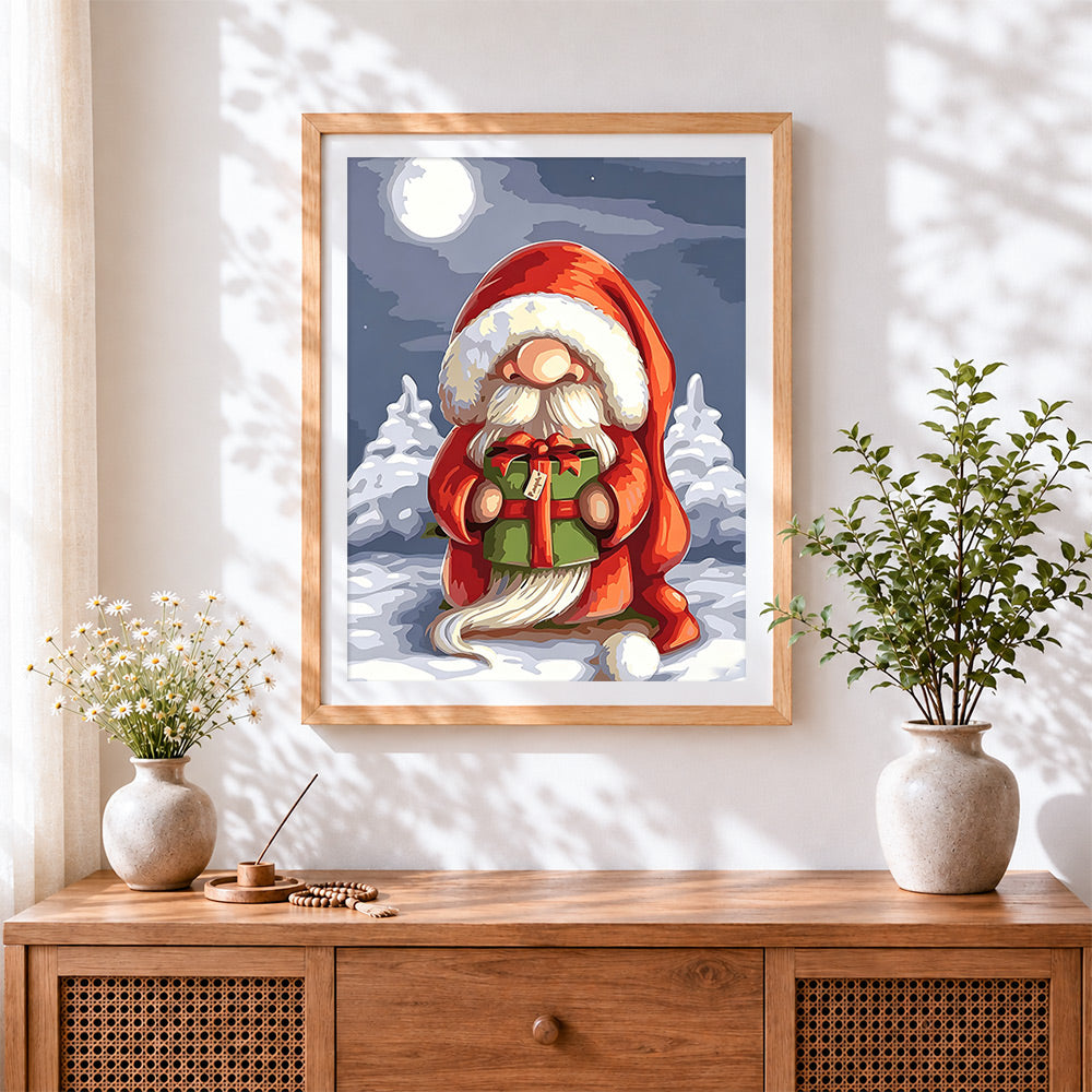 Finished christmas gnome holding a gift cross stitch artwork displayed