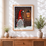 Finished christmas gnome with red hat and lantern cross stitch artwork displayed