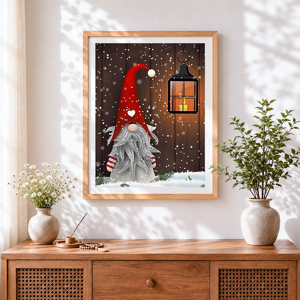 Finished christmas gnome with red hat and lantern cross stitch artwork displayed