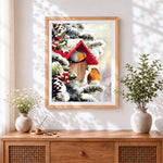Finished christmas robins and birdhouse cross stitch artwork displayed