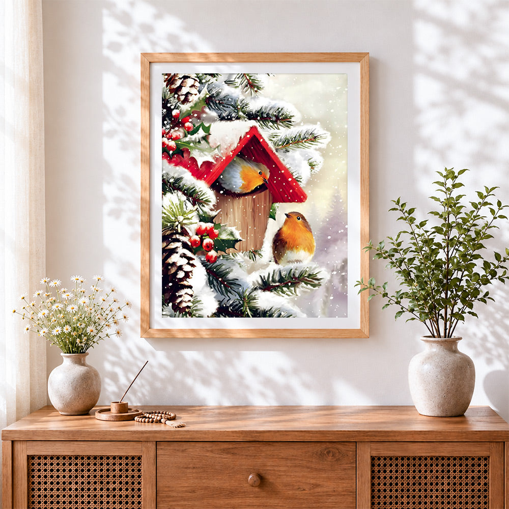 Finished christmas robins and birdhouse cross stitch artwork displayed